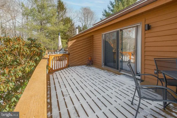 a view of balcony with wooden floor and fence