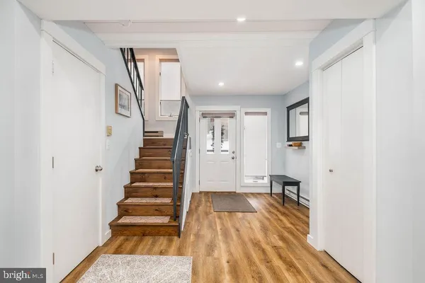 a view of entryway with wooden floor and stairs