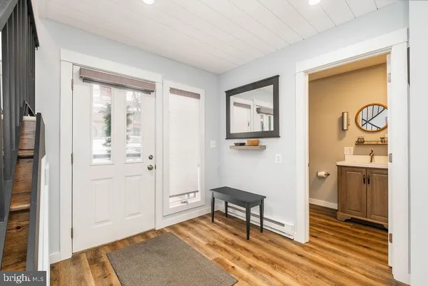 a view of entryway with wooden floor and stairs