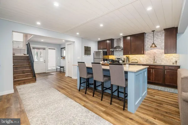 a large kitchen with a table and chairs