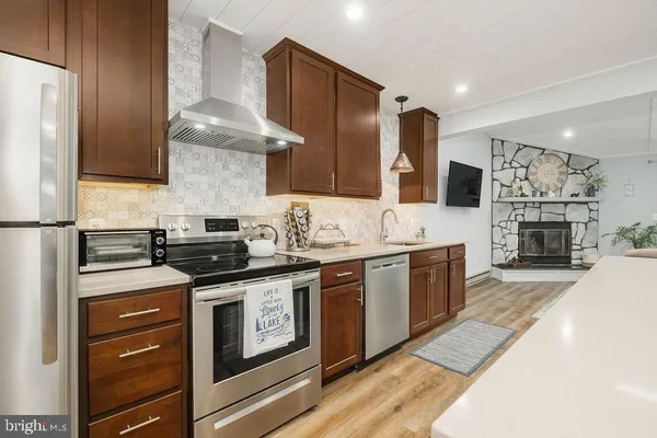 a kitchen with stainless steel appliances granite countertop a stove and a refrigerator