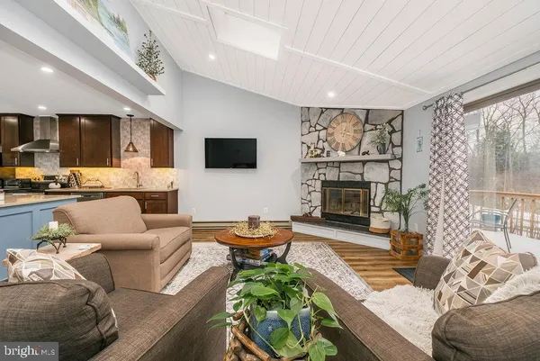 a living room with furniture fireplace and a flat screen tv