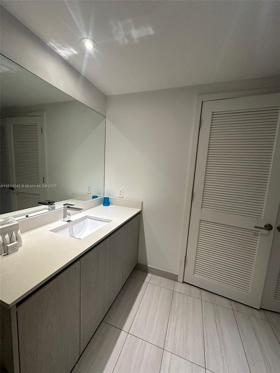 4010 South Ocean Drive, Unit R1507 Hollywood, FL 33019 - Photo 7 of 14 a bathroom with a sink and a mirror