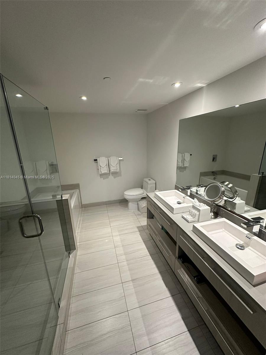 4010 South Ocean Drive, Unit R1507 Hollywood, FL 33019 - Photo 9 of 14 a large kitchen with a stove and white cabinets