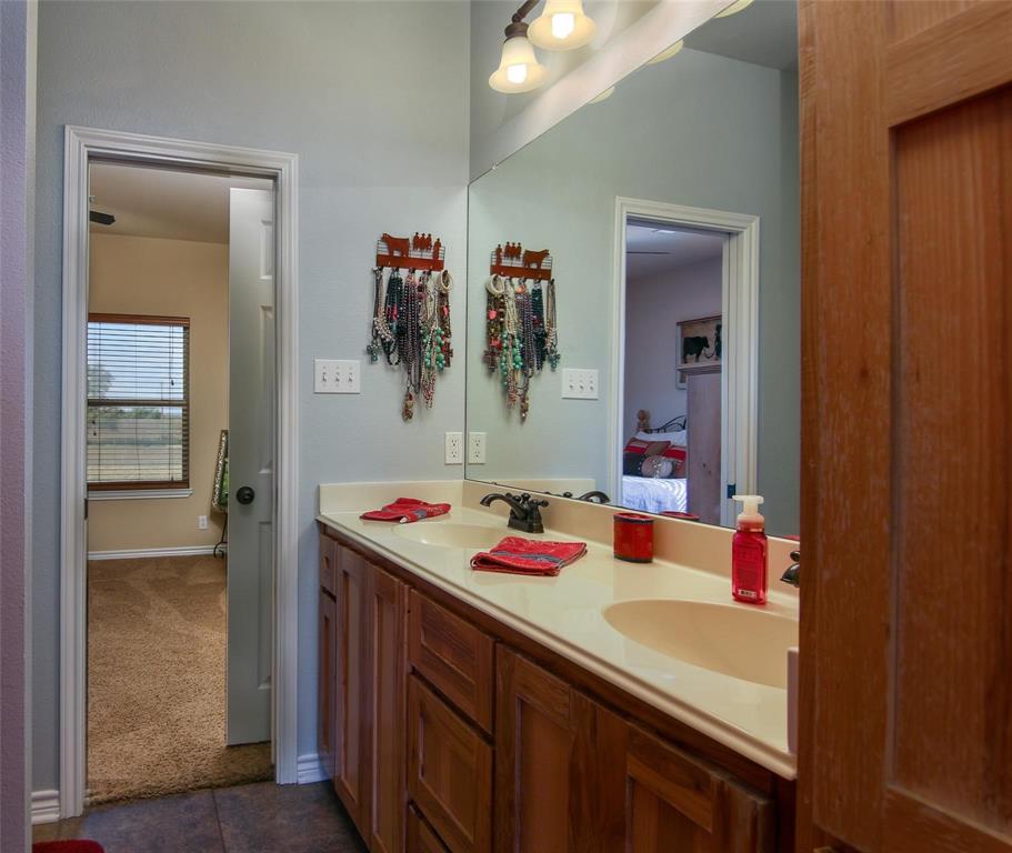 7158 Luella Road Sherman, TX 75090 - Photo 12 of 40 a bathroom with a sink vanity and mirror