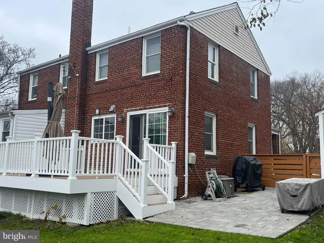 a view of a house with a yard and deck