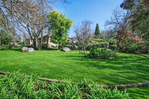 a view of house with swimming pool and patio