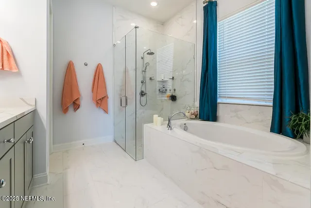 a bathroom with a double vanity sink mirror and shower