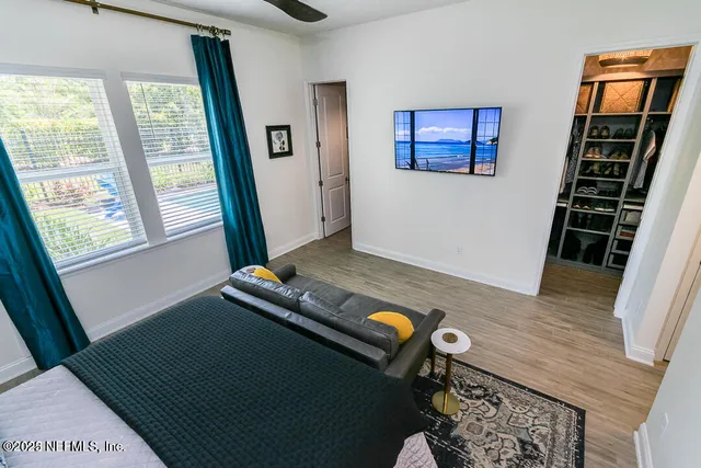 a living room with furniture and wooden floor