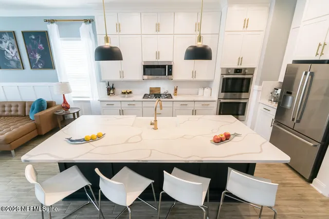 a large kitchen with a table and chairs