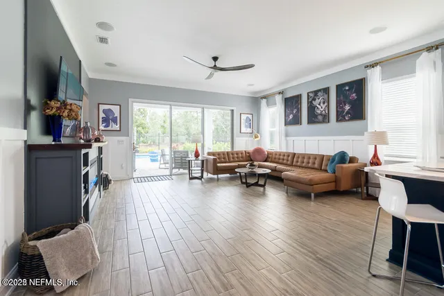 a living room with furniture and a wooden floor
