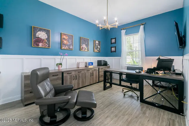 a living room with furniture a window and a wooden floor