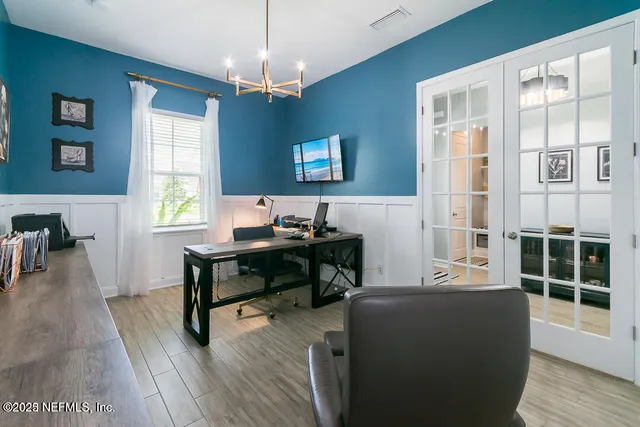 an aerial view of a wooden table and chairs