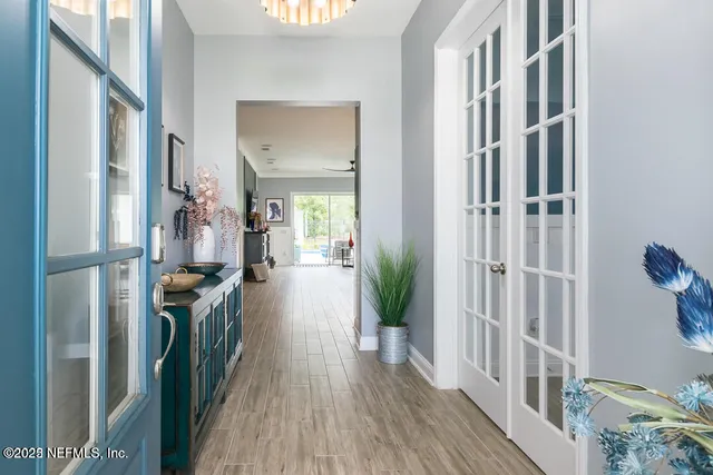 a view of a hallway with wooden floor and staircase