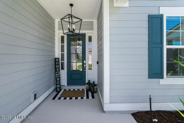 a view of a house with backyard sitting area and garden