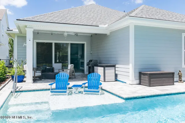 a living room with patio furniture and a garden