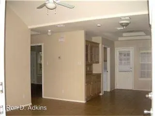 a view of a hallway with wooden shelves