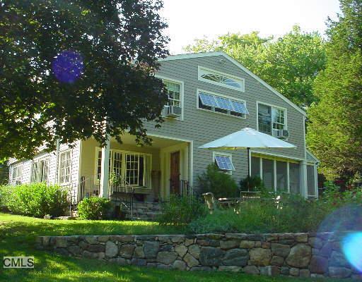 293 East Hunting Ridge Road Stamford, CT 06903 - Photo 1 of 1 a front view of a house with a yard and green space