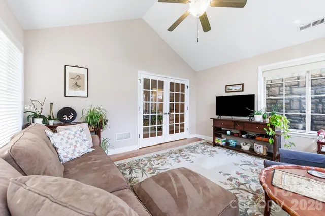 a kitchen with stainless steel appliances granite countertop a sink a stove a refrigerator and island with wooden floor