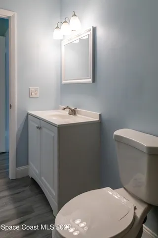 a bathroom with a sink a toilet and mirror