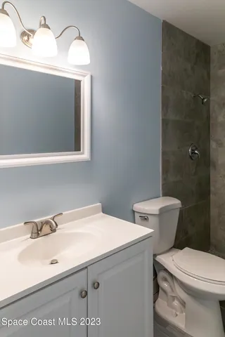 an empty room with wooden floor and closet