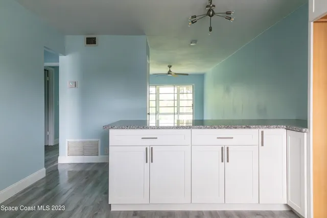 a kitchen with a sink cabinets and a window