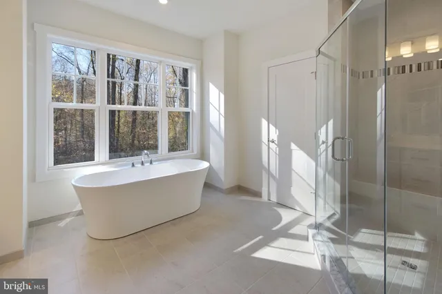 a bathroom with a bathtub and shower