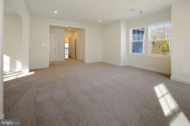 an empty room with windows and closet