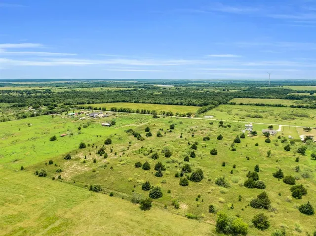 a view of a field with an ocean