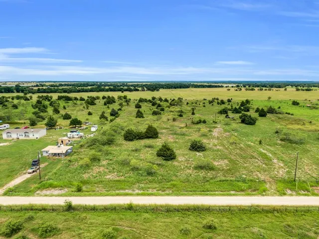 a view of a field with an ocean