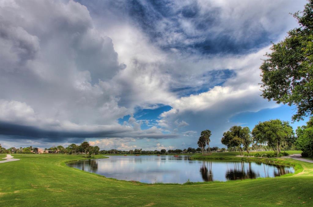 5301 Mahogany Run Avenue, Unit 1023 Sarasota, FL 34241 - Photo 12 of 56 a view of a lake with houses in the back