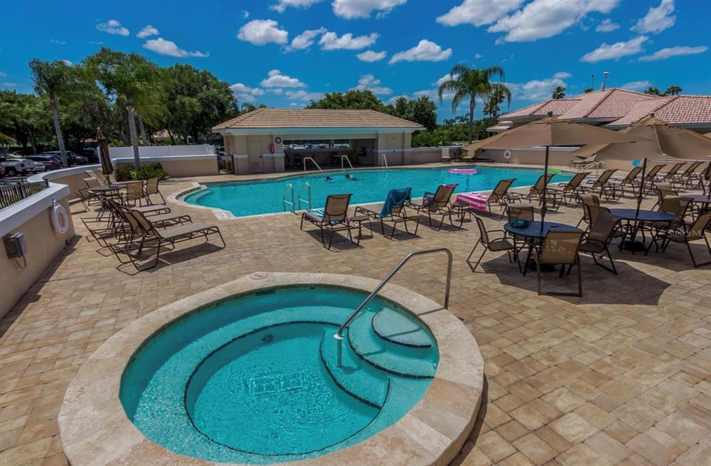 5301 Mahogany Run Avenue, Unit 1023 Sarasota, FL 34241 - Photo 13 of 56 a view of a swimming pool with lounge chairs