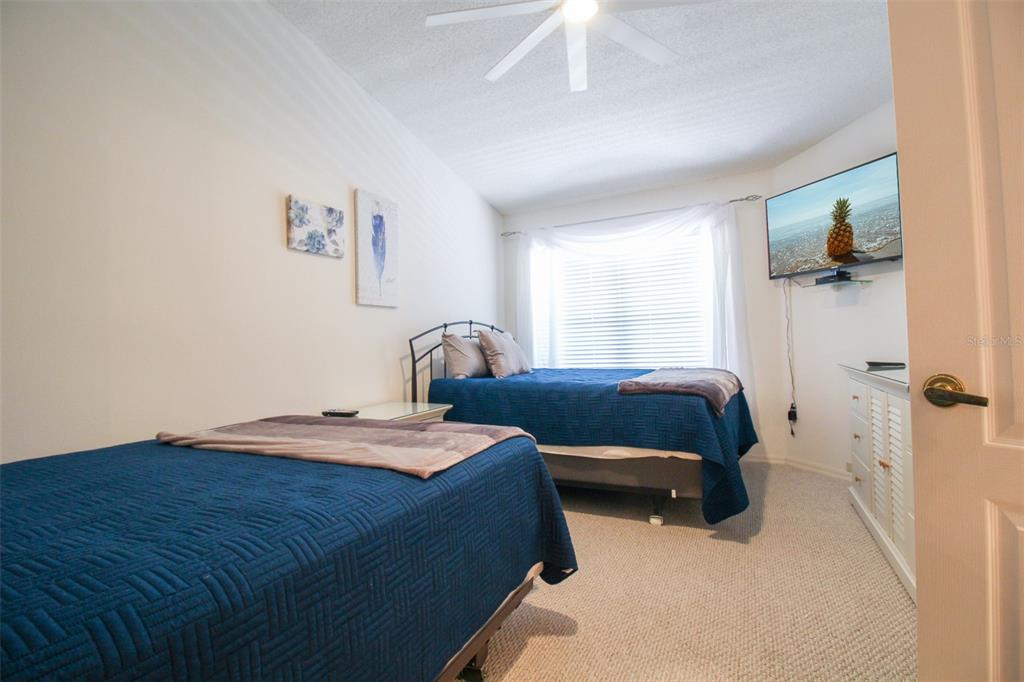 5301 Mahogany Run Avenue, Unit 1023 Sarasota, FL 34241 - Photo 20 of 56 a bedroom with a bed and a window