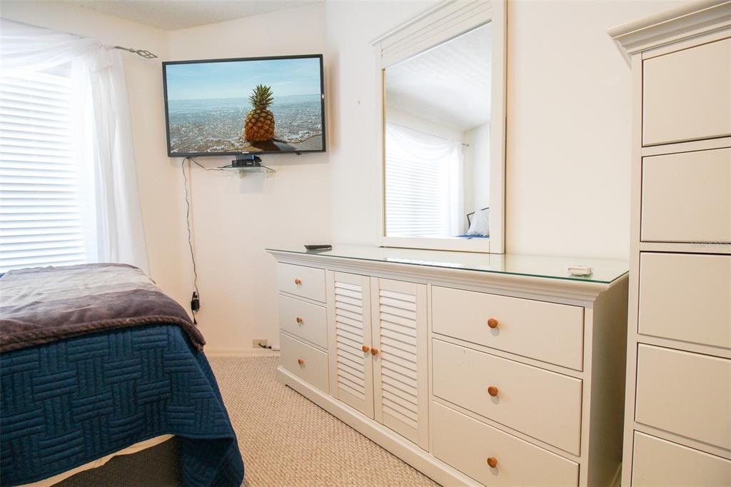 5301 Mahogany Run Avenue, Unit 1023 Sarasota, FL 34241 - Photo 21 of 56 a bedroom with a bed and a dresser