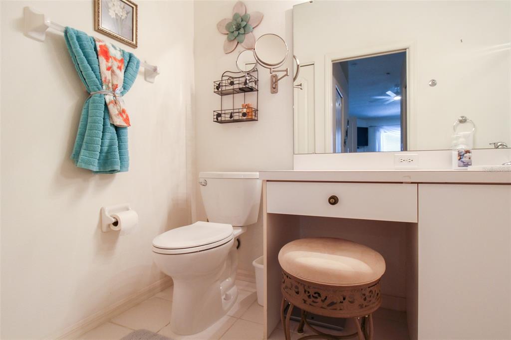 5301 Mahogany Run Avenue, Unit 1023 Sarasota, FL 34241 - Photo 23 of 56 a bathroom with a toilet a sink and a mirror