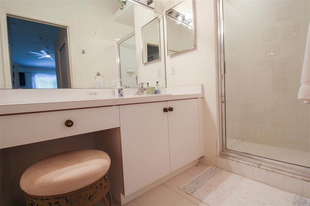5301 Mahogany Run Avenue, Unit 1023 Sarasota, FL 34241 - Photo 24 of 56 a bathroom with a toilet a sink and mirror