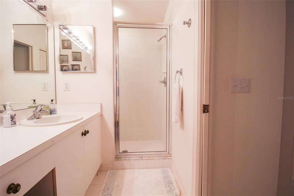 5301 Mahogany Run Avenue, Unit 1023 Sarasota, FL 34241 - Photo 25 of 56 a bathroom with a double vanity sink a mirror and a shower