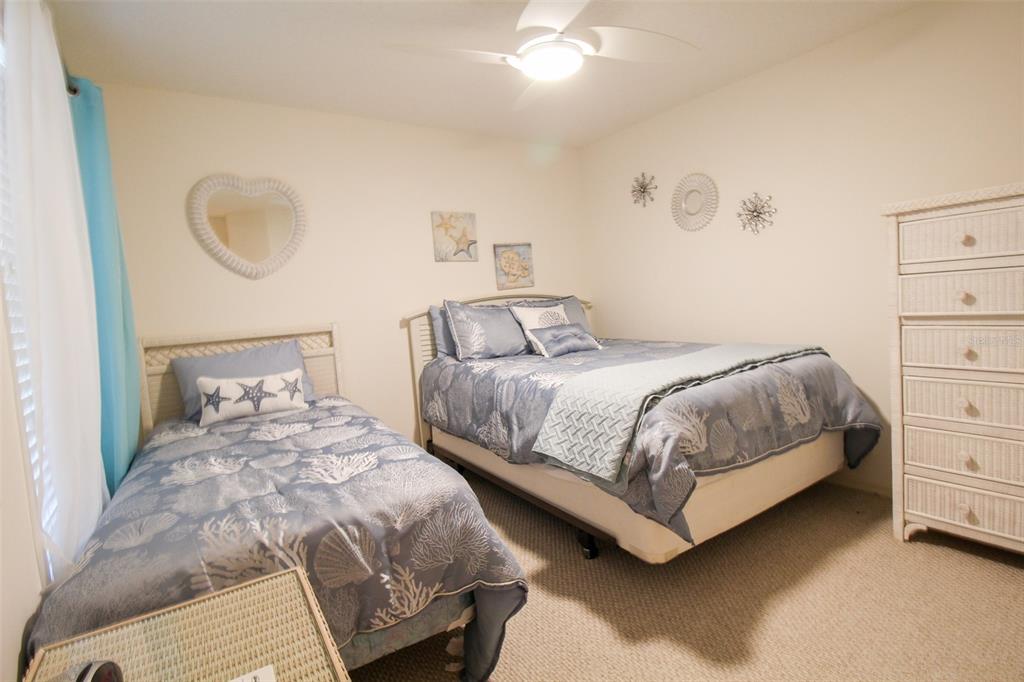 5301 Mahogany Run Avenue, Unit 1023 Sarasota, FL 34241 - Photo 30 of 56 a bedroom with a bed and a dresser