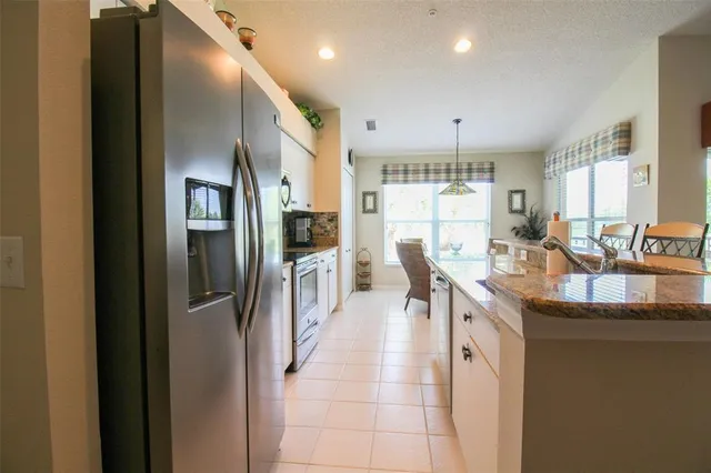 a dining room with furniture and a floor to ceiling window