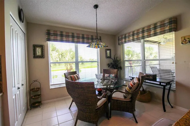 a living room with furniture and a view of kitchen