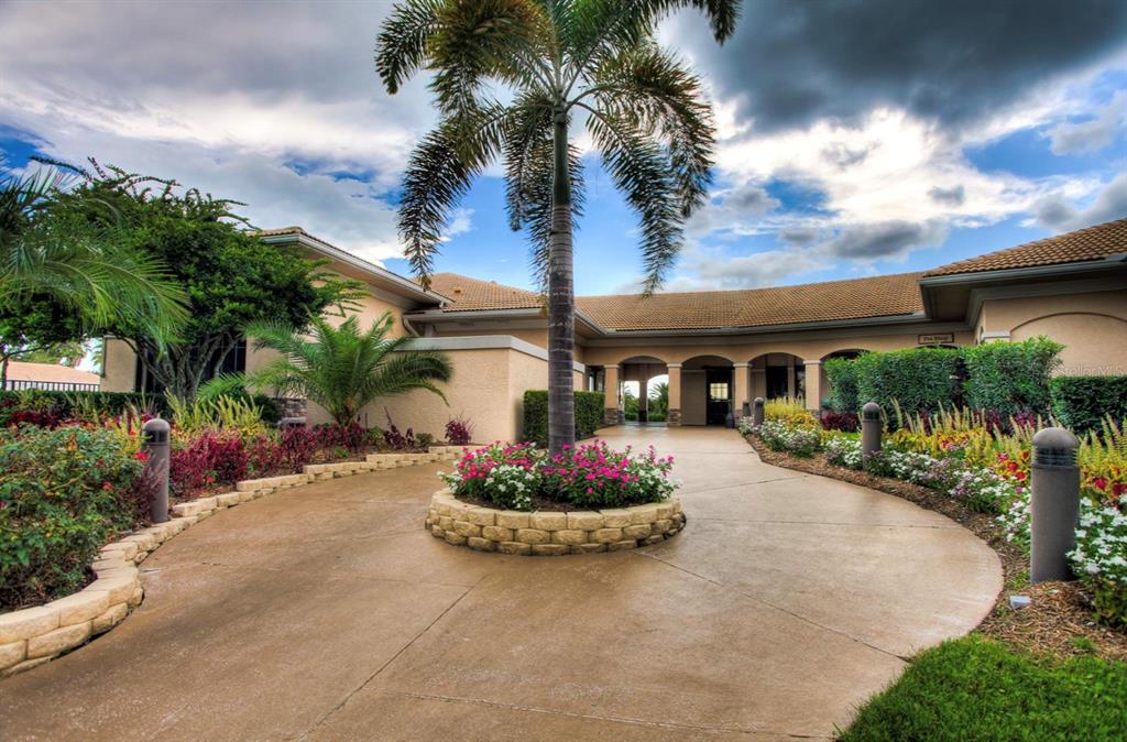 5301 Mahogany Run Avenue, Unit 1023 Sarasota, FL 34241 - Photo 4 of 56 a front view of a house with a garden and plants