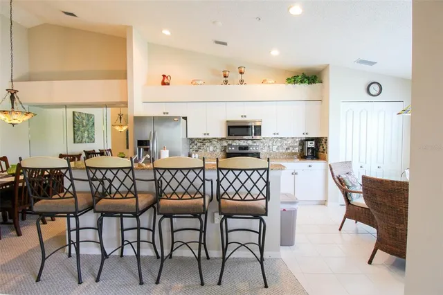 a living room with furniture a couch and a flat screen tv