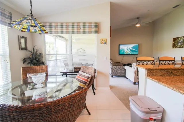 a view of a porch with a table and chairs