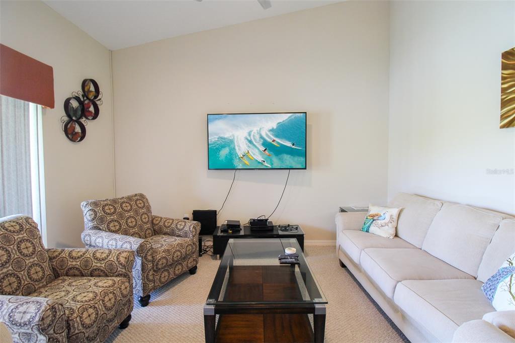 5301 Mahogany Run Avenue, Unit 1023 Sarasota, FL 34241 - Photo 46 of 56 a living room with furniture and a couch