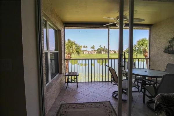 a view of a porch with a table and a chair