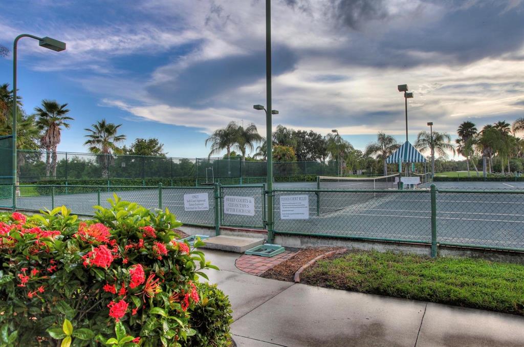 5301 Mahogany Run Avenue, Unit 1023 Sarasota, FL 34241 - Photo 5 of 56 a green field with flowers in front of it