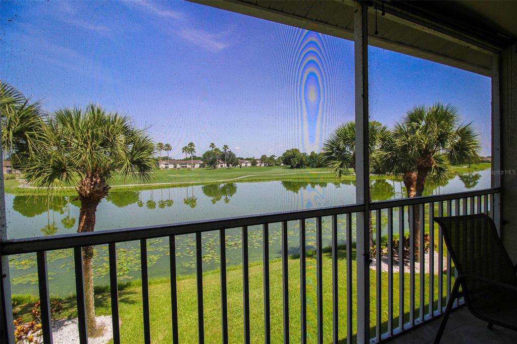 5301 Mahogany Run Avenue, Unit 1023 Sarasota, FL 34241 - Photo 51 of 56 a view of a porch with a yard