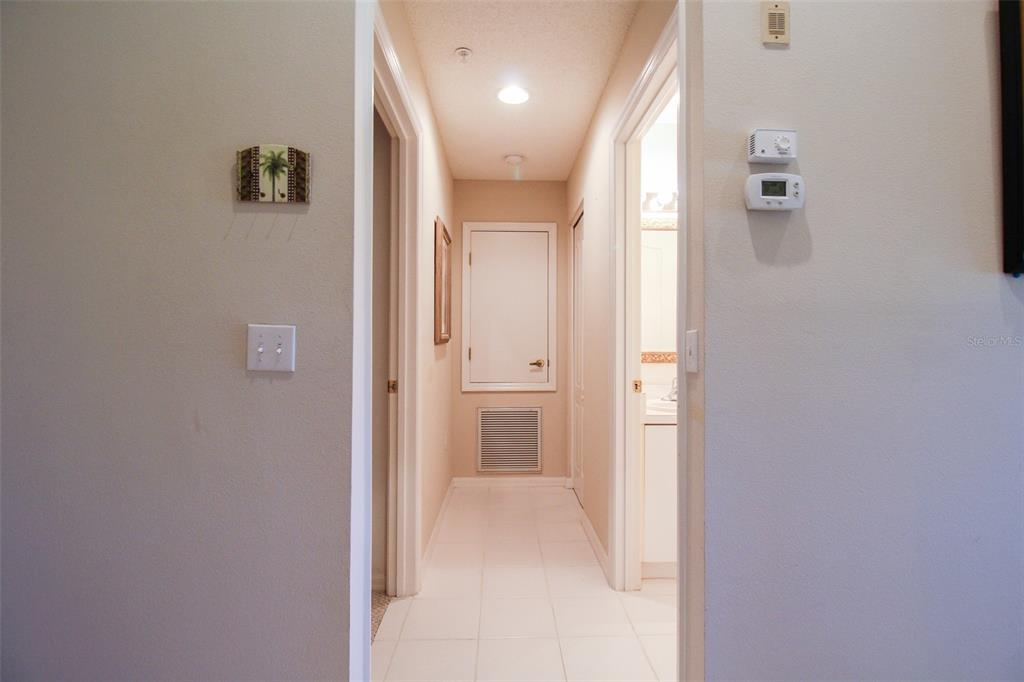 5301 Mahogany Run Avenue, Unit 1023 Sarasota, FL 34241 - Photo 56 of 56 a view of a hallway with wooden floor and a bathroom