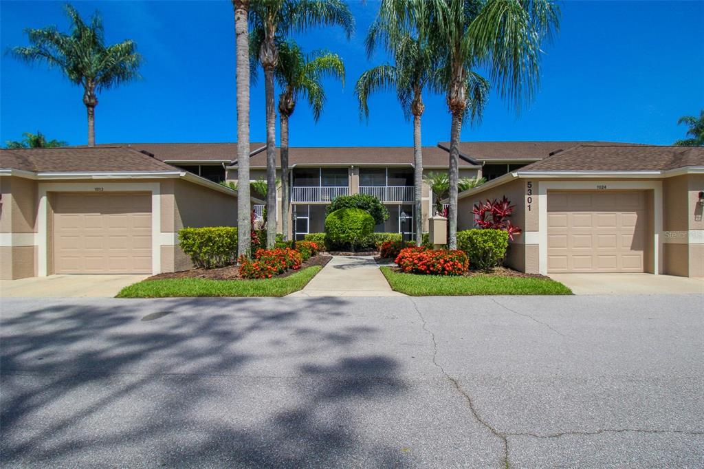 5301 Mahogany Run Avenue, Unit 1023 Sarasota, FL 34241 - Photo 10 of 56 a front view of a house with garden