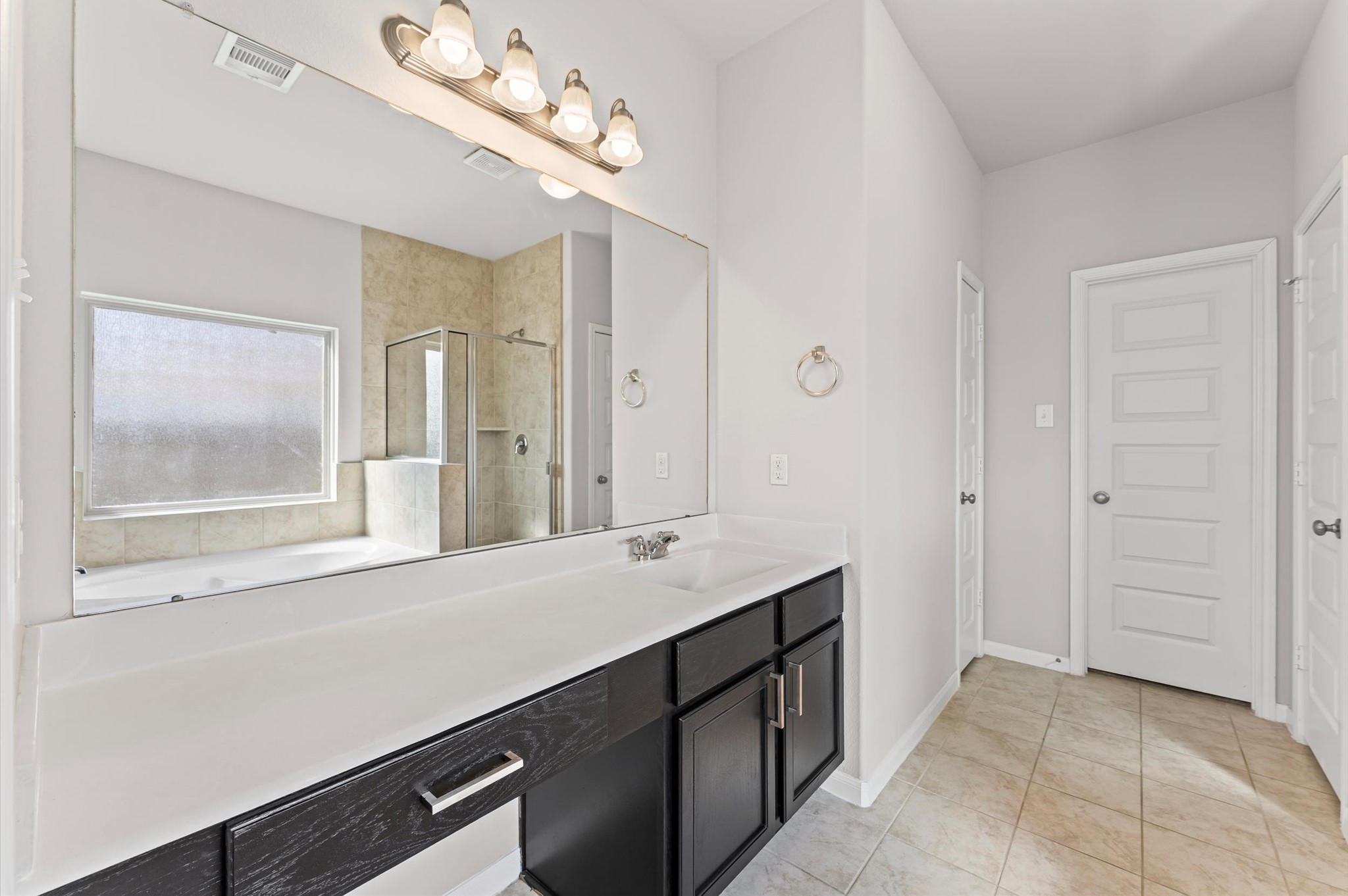 15207 Lake Erie Drive Humble, TX 77396 - Photo 15 of 37 a bathroom with a sink a vanity a large mirror and a shower